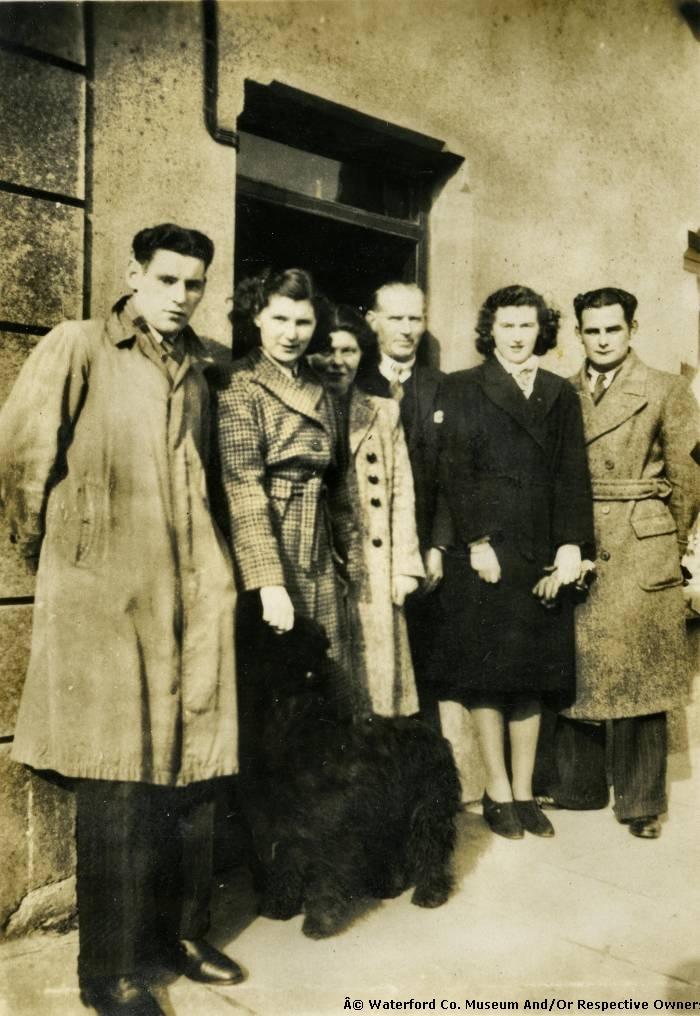 A Small Group Of People Posing For A Photograph
