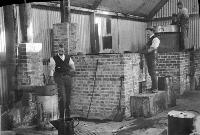 Factory Interior With Workers Tending Kilns